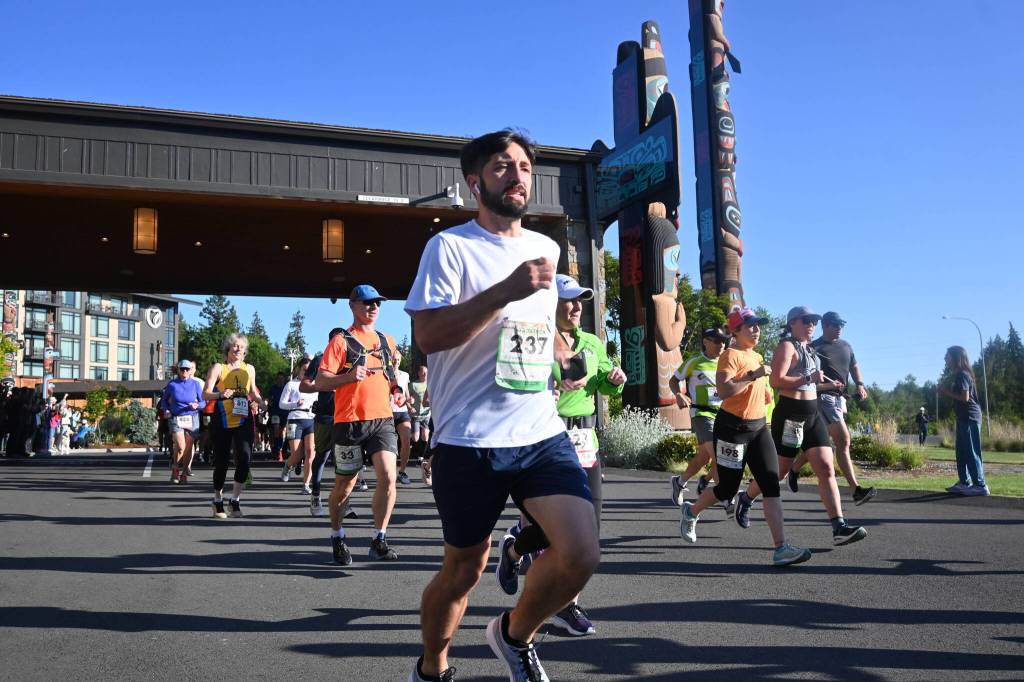 Sequim Gazette photo by Michael Dashiell / Seth Bailey of Spring, Texas, and other runners break from the starting line of the full North Olympic Discovery Marathon in Blyn on June 4.
