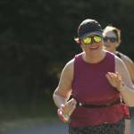 Sequims Sarah Castell is all smiles as shes greeted by friends and family near an aid station during the North Olympic Discovery Marathon.