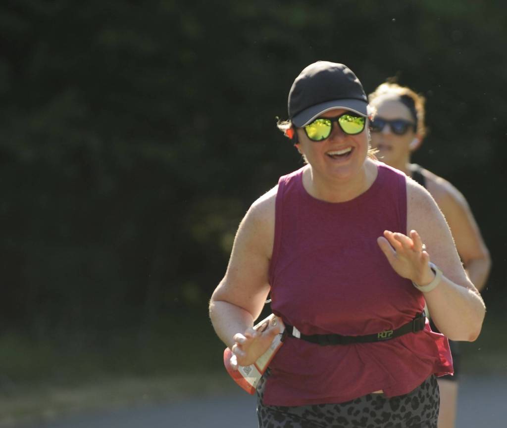 Sequims Sarah Castell is all smiles as shes greeted by friends and family near an aid station during the North Olympic Discovery Marathon.