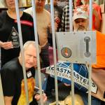 Photo courtesy of Skwim Toastmasters / Members of the Skwim Toastmasters Club prepare for jail time as part of the annual fundraising drive at KSQM 91.5 FM. Pictured are (back row, from left) Lex Myers, Douglas Woodall, Ty Youngblood and Lindy MacLaine, (middle row, from left) Judy Stein and Kyle Hall, and (front row, from left) Jon Tyson and guide-dog-in-training Adele.