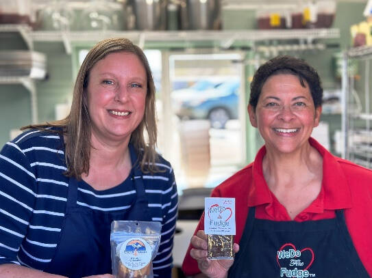 Photo courtesy of Christina Norman / Teresa Crecelius, left, of Cascade Caramel, and Christina Norman of WeDo Fudge offer treats and prayer at the WeDo Fudge drive-thru stand in Carlsborg.