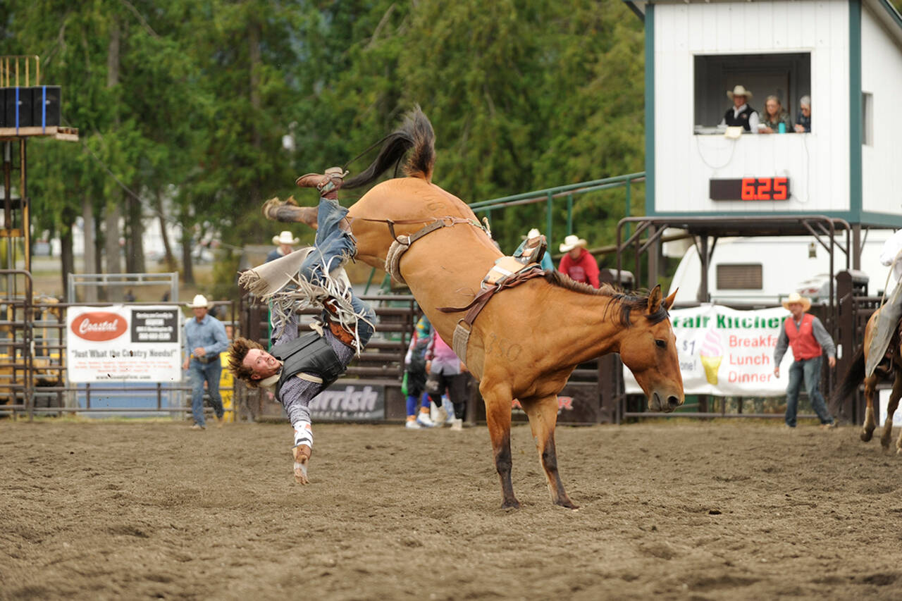 Sequim Gazette file photo by Matthew Nash / Cooper Wicks nearly makes the 8-second mark while bareback riding at the Clallam County Fairs Rodeo in 2019.