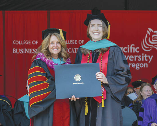 Photo courtesy of Pacific University
Katelyn Michelle Doyle of Sequim, right, accepts her Pacific University doctorate in optometry from school president Dr. Jennifer Coyle at Pacifics commencement ceremony on May 20.