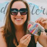 Photo courtesy of Sequim Farmers & Artisans Market
Sarah Harrington of Cookie Daughters holds one of her delicious, themed iced cookies for Pride Month.