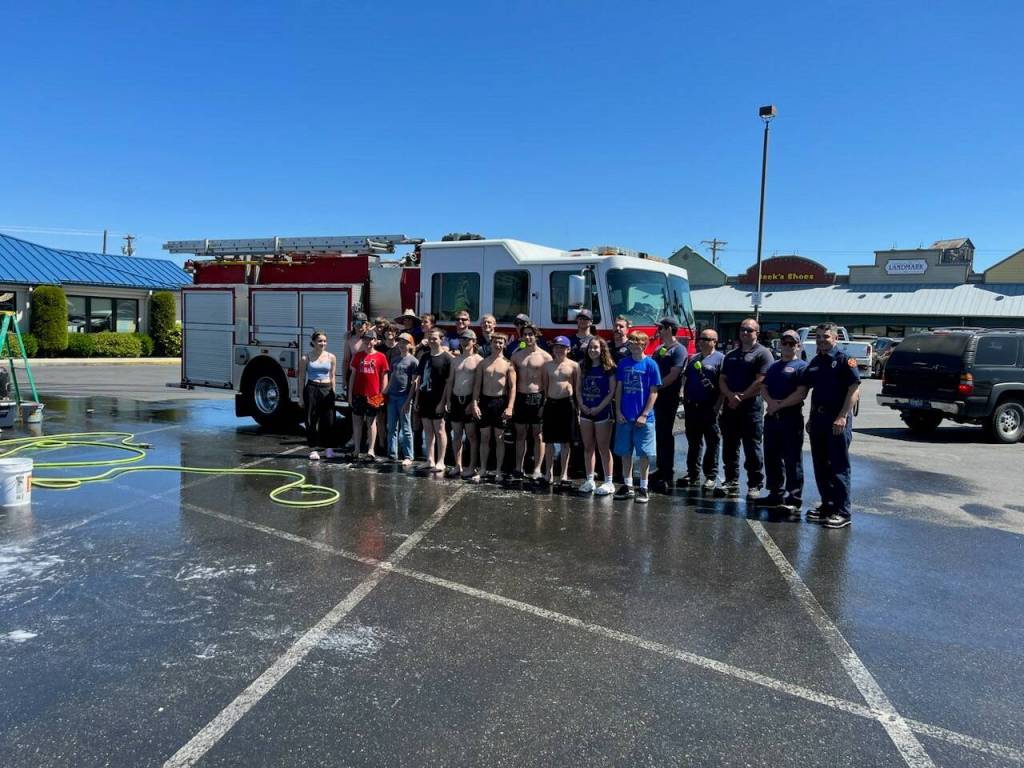Photo courtesy of Clallam County Fire District 3 / Members of Captain Chad Cates Clallam County Fire District 3 duty crew stop by to support the coachs Sequim High School wrestling team car wash fundraiser on June 3. Aside from family, district representatives said, these two groups of individuals ranked highest for Cate, the late firefighter and head varsity wrestling coach who passed away while on the job on Jan. 12. The benefits were two-fold: the engine got a stellar cleaning from the wrestlers and the duty crew got to honor their fallen brother by supporting something close to his heart, district representatives said.