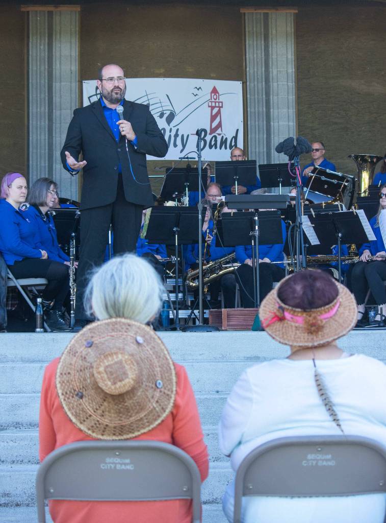 Sequim Gazette photo by Emily Matthiessen / Sequim City Band director Tyler Benedict and the community group entertain a crowd at the bands free June 11 concert, Building a Legacy.