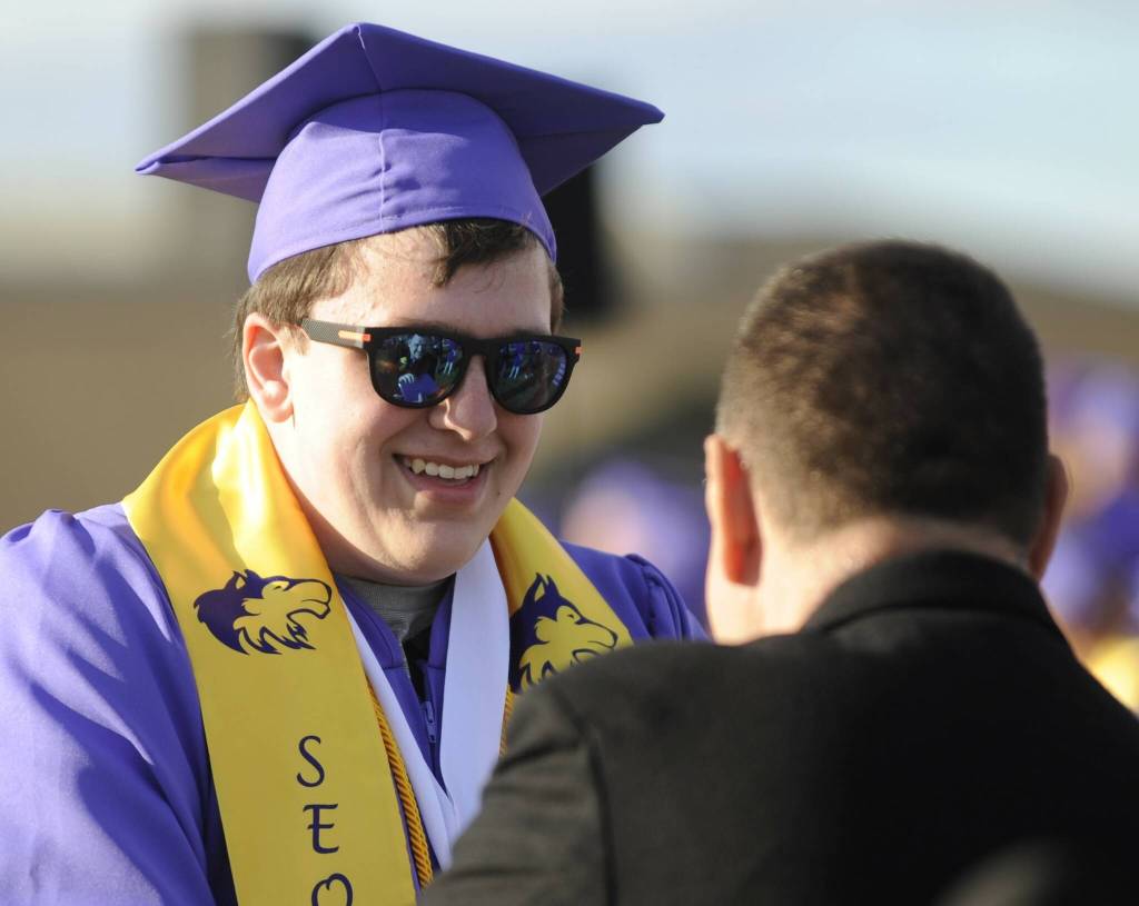 Sequim Gazette photo by Michael Dashiell / Graduating senior Jonathan Bowden receives his diploma from school board president Eric Pickens at the Sequim High School commencement ceremony on June 16.