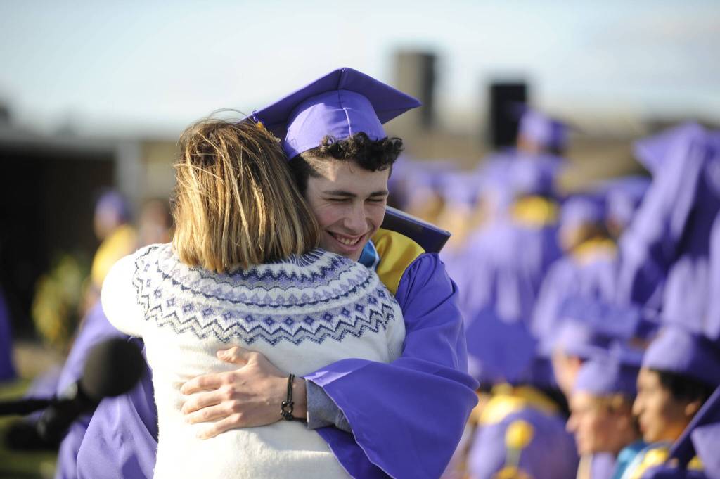 Sequim Gazette photoS by Michael Dashiell 
Graduating senior Ayden Humphries gets a hug from school board member Patrice Johnston at the Sequim High School commencement ceremony on June 16.