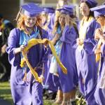 Sequim Gazette photo by Michael Dashiell / Ruby Coulson gathers her graduation sash and regalia as, despite some windy conditions, she and more than 160 classmates accepted diplomas at Sequim High Schools commencement ceremony on June 16.