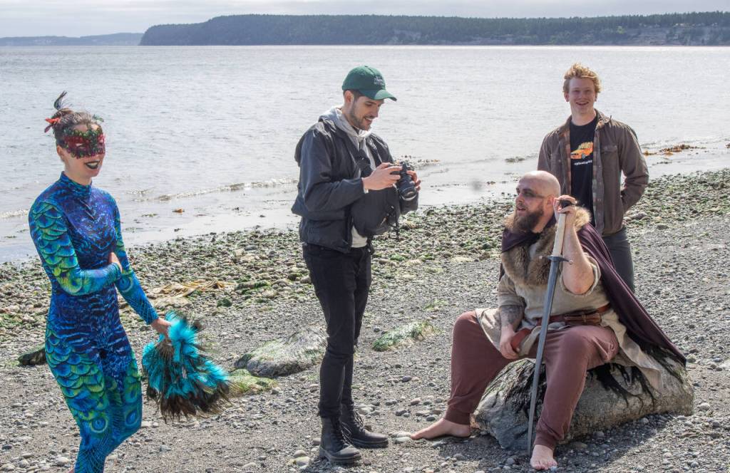 Sequim Gazette photo by Emily Matthiessen /From left, Mia Underwood, mermaid, Ben May, videographer, Andrew Lumm, Blackbeard the pirate, and Logan Laxson, who will play the older Peter Pan in Neverland, pause during a video/photo shoot at Port Williams beach. Sequim Acrobatics has been working for nearly a year on the production, which will be performed for two evenings at Sequim High School auditorium.