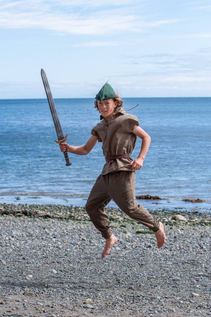 Sequim Gazette photo by Emily Matthiessen / Peter Pan, played by Rivers Maynard, flies across the Port Williams beach with his longsword drawn for a possible pirate confrontation. Maynard is one of 39 performers in Sequim Acrobatics upcoming production, Neverland, which can be experienced on Friday or Saturday of this week at Sequim High School Auditorium.