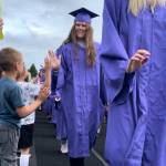 Sequim Gazette photo by Matthew Nash
Sequim senior Angel Wagner high-fives kindergartners during the annual Grad Walk on June 16. Students and staff from area schools lined the Sequim School District track to congratulate the 12th graders on the morning of their graduation.