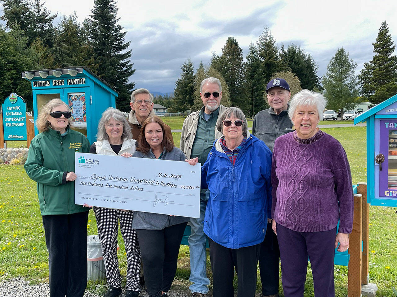 Photo courtesy Susan Harris
Olympic Unitarian Universalist Fellowship volunteers accept a $2,5000 check from Chrystal Patterson, fourth from left, to support the Agnew Little Free Pantry and Little Free Library. Pictured, from left, are Dianne Whitaker, Susan Harris, Dave Large, Patterson, John Toppenberg, Margo Hewitt and Penny Burdick.