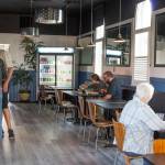 Sequim Gazette photo by Emily Matthiessen / The interior of FnChips hosts a long row of tables, lit by overhead lights and the windows of the old Episcopal church at 134 S. Second Ave.