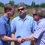 Sequim Gazette photo by Michael Dashiell / From left, U.S. Rep. Derek Kilmer talks with Clallam County commissioners Mark Ozias and Randy Johnson at a groundbreaking of the Brownfield Road Project in Sequim on July 5.