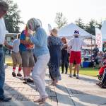 Sequim Gazette photo by Emily Matthiessen / The Buck Ellard Band draws dancers from the crowd during the Independence Day celebration.