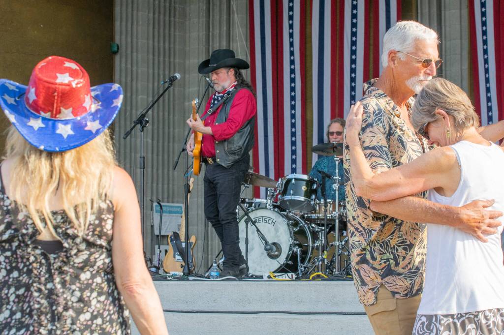 Sequim Gazette photo by Emily Matthiessen / The Buck Ellard Band draws dancers from the crowd during the Independence Day celebration.