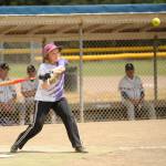 Sequim Gazette photo by Michael Dashiell / Annette Hanson of the Sequim Greywolves rips a single to left field as her squad rallies for a win over the Victoria Raiders on July 8 at Carrie Blake Community Park.