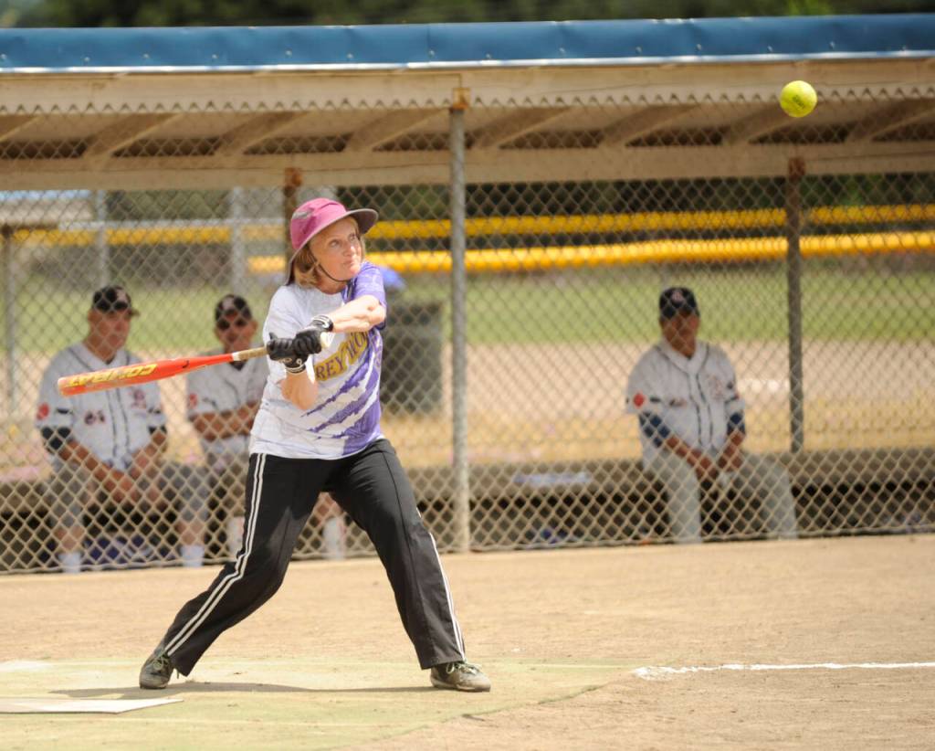 Sequim Gazette photo by Michael Dashiell / Annette Hanson of the Sequim Greywolves rips a single to left field as her squad rallies for a win over the Victoria Raiders on July 8 at Carrie Blake Community Park.