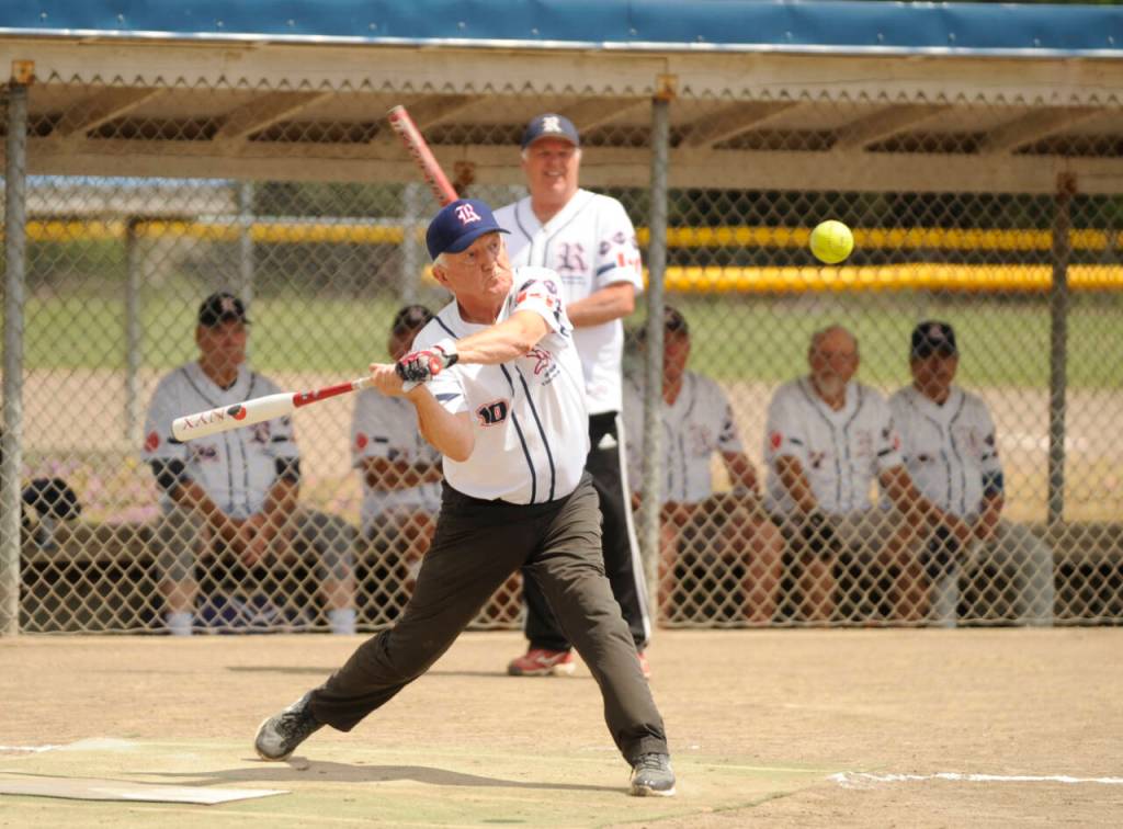 With teammate Ron Brown looking on, Victoria Raiders Vern Benn bats in the seventh inning of a game agains the Sequim Greywolves on July 8 at Carrie Blake Community Park.