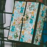 Photo courtesy of Sequim Farmers & Artisans Market / A close-up of a custom crafted Alice in Wonderland-themed notebook. The notebooks, made from paper and chipboard, each take about four hours to craft. The latch is fastened with brads.