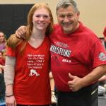 Mya Herrera, a standout wrestler at Cascade High School (Leavenworth), shares a moment with former NCAA champ Gene Mills ant a wrestling camp in Sequim last week. Herrera, donning a shirt she made for the camp (as she did at the 2022 camp), suffered hyperextended arm on the camps first day but expects to be ready to go in the late fall for her season. She placed third in the 205 weight class (girls 1B/2B/1A/2A) division at MatClassic as a junior in 2022-23.
