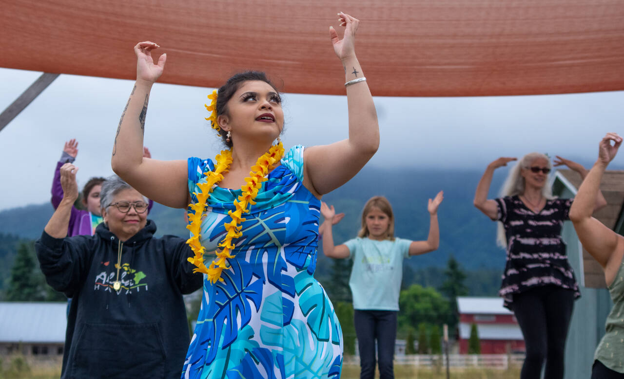 Sequim Gazette file photo by Emily Matthiessen 
Casara Desiree Hemakanamaikapu`uwai Caro leads members of a Sequim audience on in a Hawaiian dance in the field behind the Sequim library in 2022. Join Caro and instructors from H<strong>ā</strong>lau Hula Ka Lei Mokihana I Ka Ua Noe for a Hawaiian hula demonstration on Saturday, July 29.