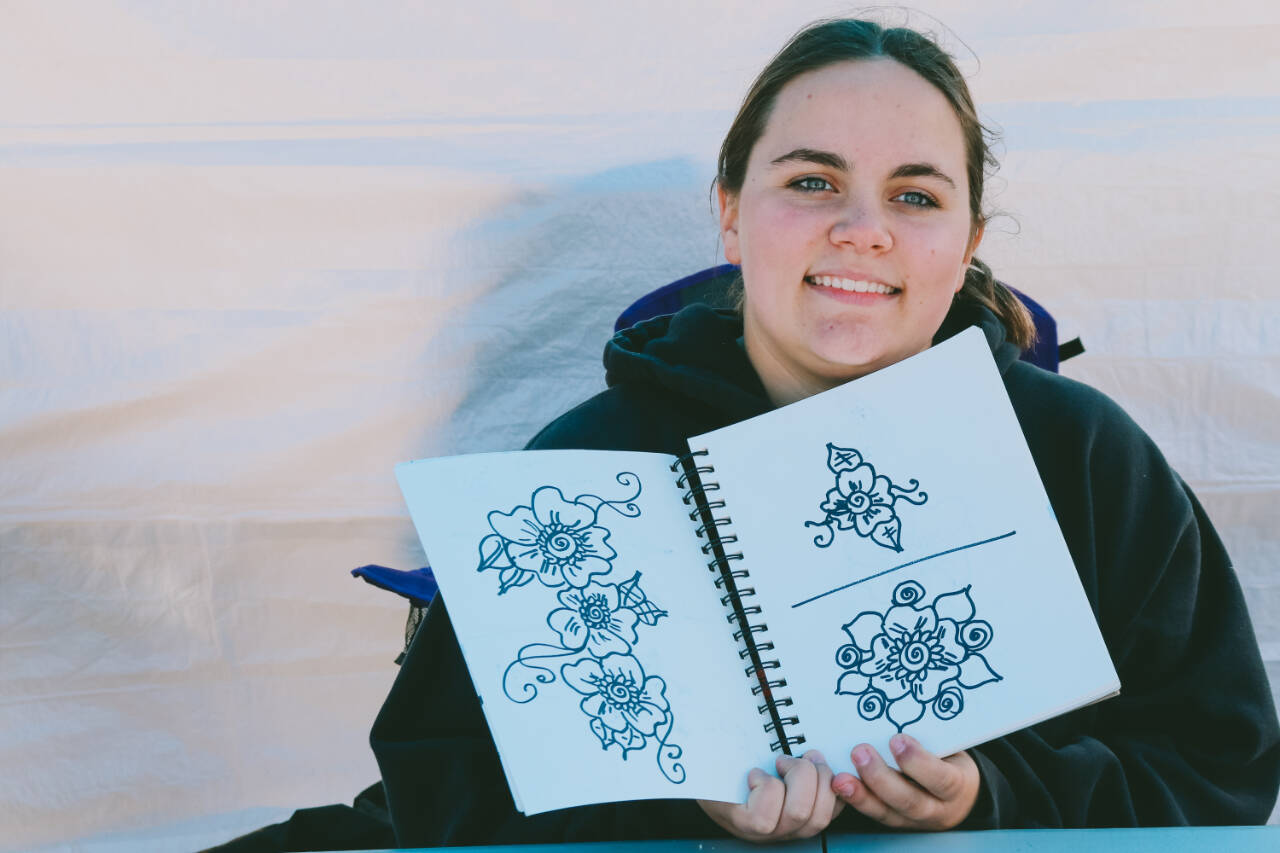 Patience Edwards, a Sequim High Student and owner of Wild Feather Henna, showcases one of her many designs that customers can choose from for their own temporary henna tattoo.
