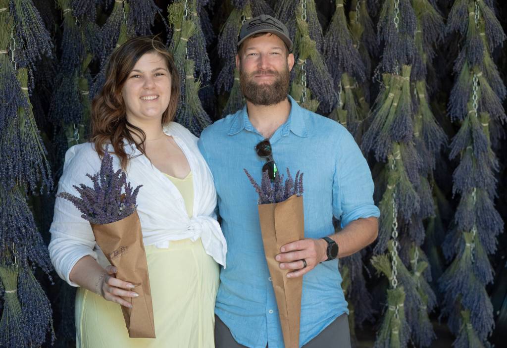 Sequim Gazette photo by Emily Matthiessen / Danyel Waller and Andy Masters of Seattle enjoyed the B&B Family Farms barn during the Lavender Weekend.