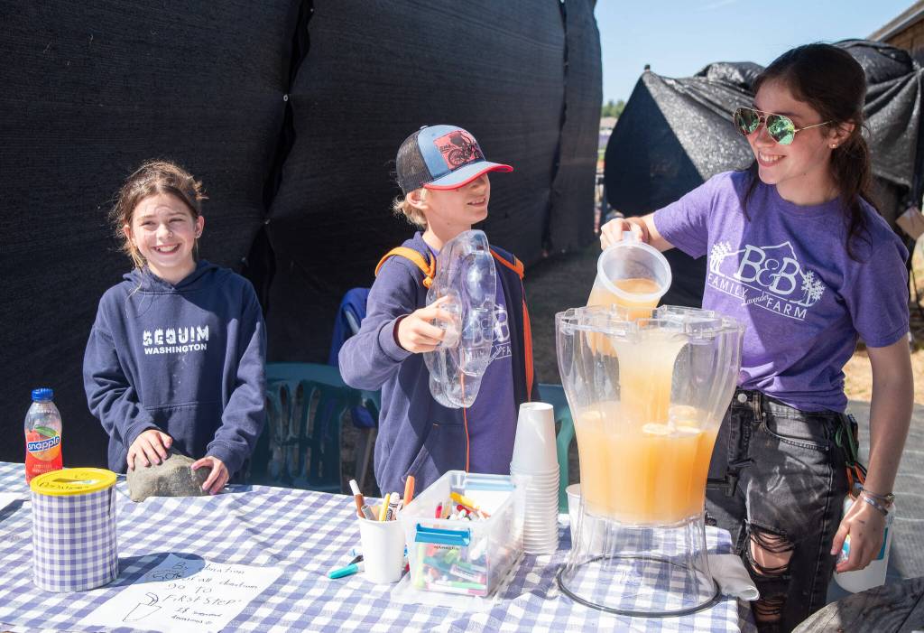 Sequim Gazette photo by Emily Matthiessen
Harper Hilliker, Marlow Kendall and Sadie Miller of B&B Family Farm serve up lemonade by donation during Lavender Weekend.