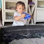 Sequim Gazette photo by Matthew Nash/ Twenty-three-month-old Casey Clark of Sequim tries filling a sachet with lavender buds inside Old Barn Lavender Farm on July 22.