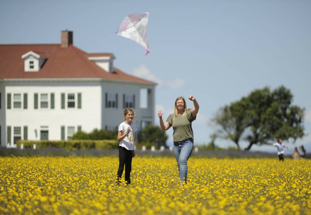 Sequim Gazette photo by Michael Dashiell
Marissa Wood of Sequim, right, helps 9-year-old Rae-Ann Wood with some kite-flying at Olympic Bluff Cidery & Lavender Farm on July 22.