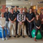 The staff at Peak Performance Center consider themselves one big family, and, Practice Manager Amber Wilkinson said, treat patients like family, too. From left to right: Michelle Fields, physical therapy assistant, Wendy Ahearn, physical therapy assistant, Daniel Pitz, physical therapist, Eric Palenik, physical therapist, Sarah Mattson, physical therapist, Aaron Staeben, occupational therapist, Thomas Keu, physical therapy assistant, Amber Wilkinson, practice manager, and Terrie Hibbard, Tina Driscoll and Danielle Florea, office staff.
