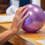 Photo by Emily Matthiessen / Therapy client Sandy Pufky-Negus uses a ball to assist with wrist extension at Peak Performance Therapy Center in Sequim.