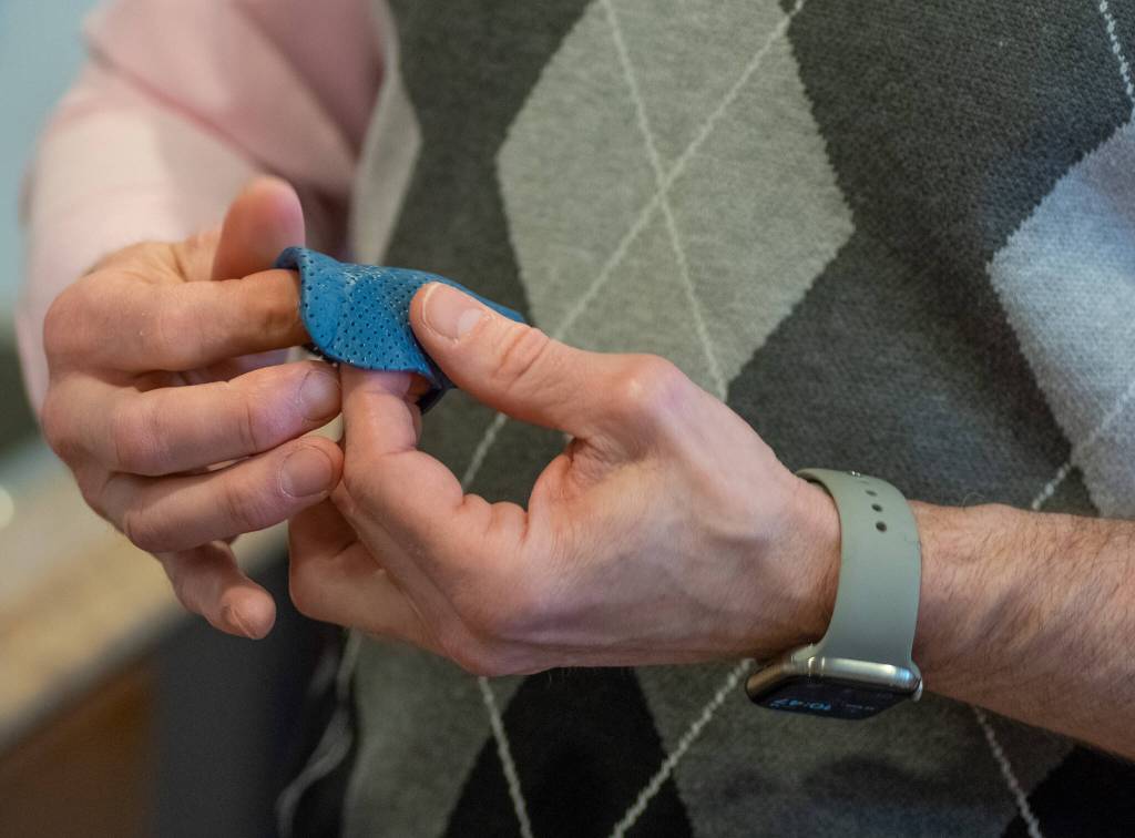 Photo by Emily Matthiessen / Aaron Staeben, certified hand therapist, pursued special training to make custom splints. Here, he is smoothing out the edges on a custom 1st CMC orthosis (a brace that supports the joint at the base of the thumb) made from a low temperature thermoplastic material.