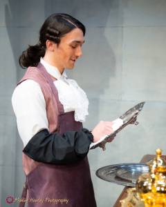 Mahina Hawley Photography / Simon Close as Brian, a Footman, polishing silver in the Port Angeles Community Players 2022 production of The Wickhams Christmas at Pemberley.