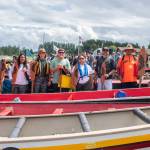 Sequim Gazette photo by Emily Matthiessen / Puyallup canoe family members pose with their canoe on the Jamestown Beach on July 25 after pulling from the lower Elwha.
