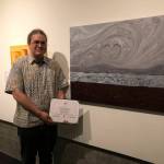 Photo courtesy of Timothy W. OConnell III
Timothy W. OConnell III stands next to his Cloudy Day At The Beach painting that earned him the Spirit of the Northwest from the In The Spirit Contemporary Native Arts Show exhibit in Tacoma in late July.