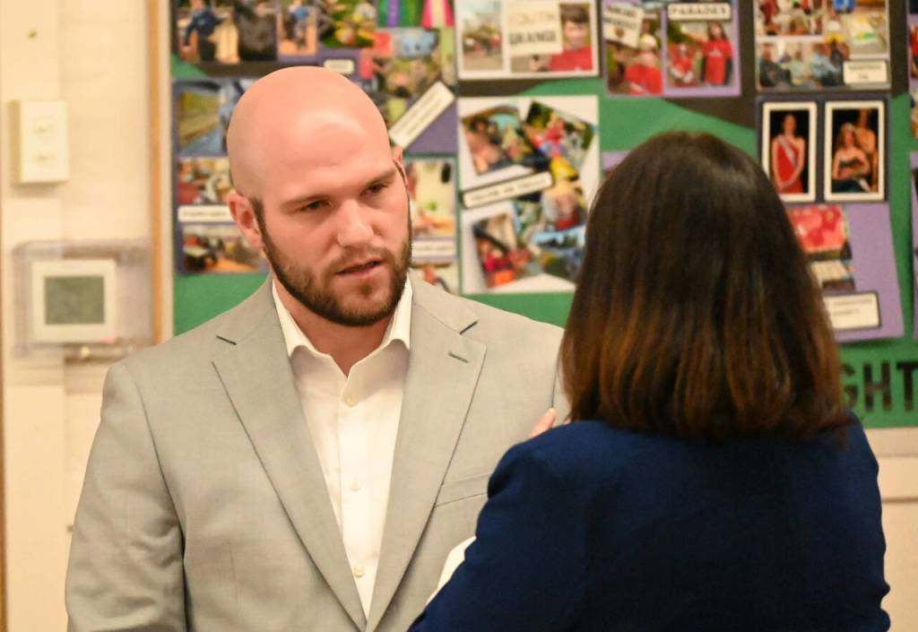 Sequim Gazette photo by Michael Dashiell / Hunter Gilliam speaks with Sequim schools superintendent Regan Nickels at the The Peoples Forum at the Sequim Prairie Grange on July 13.