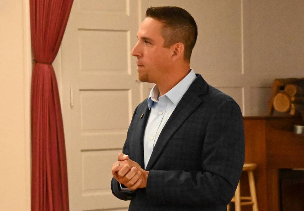 Sequim Gazette photo by Michael Dashiell / Michael Rocha speaks with an attendee of The Peoples Forum at the Sequim Prairie Grange on July 13.