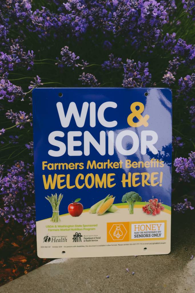 Photo courtesy of Sequim Farmers & Artisans Market/SFAM / Recipients of Women Infants and Children (WIC) and Senior Farmers Market Nutrition Program (FMNP) assistance can use their benefits directly with authorized growers for fresh fruit and vegetables. Look for growers sporting this blue sign or ask our market staff for assistance.