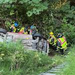 Photo courtesy Clallam County Fire District 3/ First responders prevent a vehicle from sliding further down an embankment after it went off U.S. Highway 101 Monday evening. Its driver, a 61-year-old Sequim woman, died in the crash.