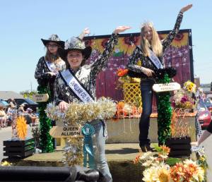 Photo by Keith Thorpe/Olympic Peninsula News Group / Clallam County Fair royalty, from left, Princess Olivia Ostlund, Queen Allison Pettit and Junior Princess Kendall Adolphe ride their festival float, which received the Irrigation Festival Chairmans Award at the Sequim Irrigation Festival in May.