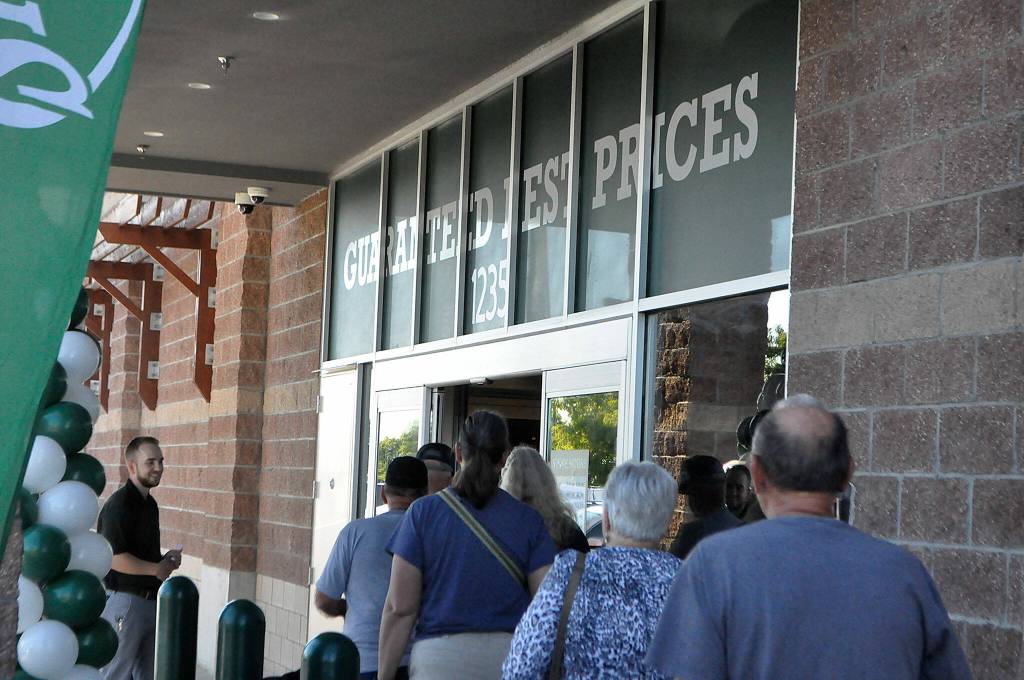 Sequim Gazette photo by Matthew Nash/ The first customers at Sequims Sportsmans Warehouse enter during its grand opening on the morning of Thursday, Aug. 10.