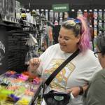 Sequim Gazette photos by Matthew Nash
Emily Leger-Foth, left, Julia Fuentes, and Tara Stratford, all of Sequim, look at fishing flies that they would use for craft projects. The trio was among the first customers inside Sportsmans Warehouse during its grand opening on Aug. 10.