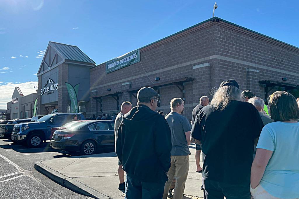 Sequim Gazette photo by Matthew Nash/ The first customers at Sequims Sportsmans Warehouse line up for the stores grand opening on the morning of Thursday, Aug. 10.