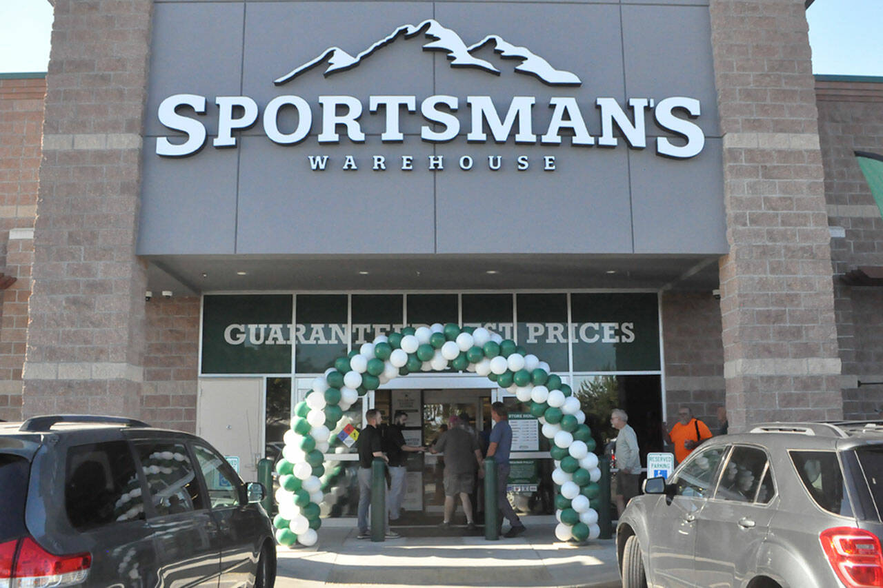 The first customers at Sequims Sportsmans Warehouse enter during its grand opening on the morning of Thursday, Aug. 10.