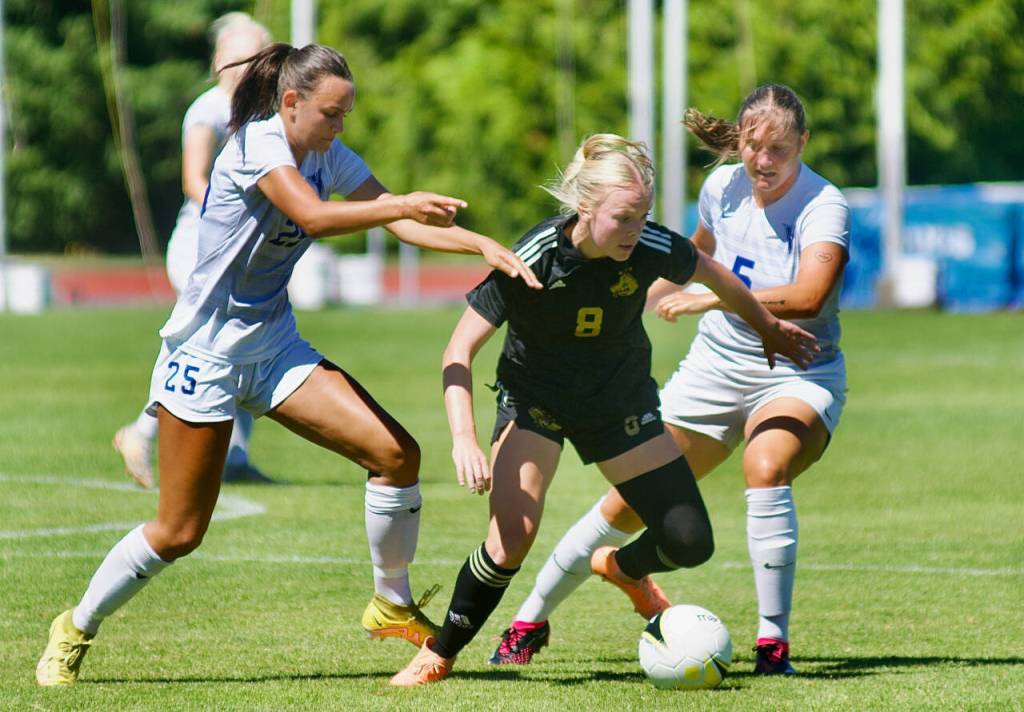 PhotoS by Rick Ross/Peninsula College
Anna Petty of Port Angeles, center, looks to keep possession in a preseason scrimmage at the University of Victoria on Aug. 13. Petty and the Pirates fell to their hosts, 4-2.