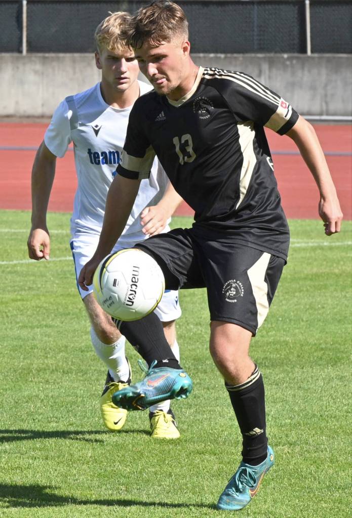 Photo by Rock Ross/Peninsula College / Peninsulas Maurin Frehner, a sophomore midfielder from Zurich, Switzerland, looks for an open teammate in the Pirates split squad scrimmage against the University of Victoria on Aug. 11.