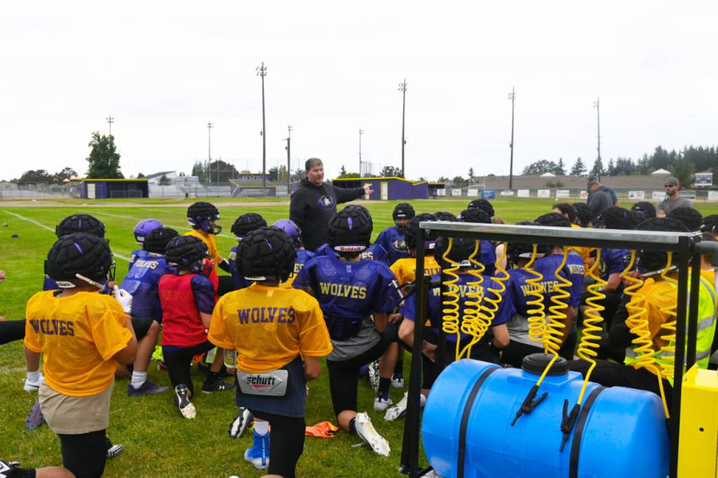 Sequim Gazette photo by Michael Dashiell / Sequim High head coach Erik Wiker talks with his football squad in a preseason practice last week as the Wolves prep for their Sept. 1 season-opener. Wiker is Sequim Highs all-time leader with 121 victories and eight league championships since taking over in 2004.